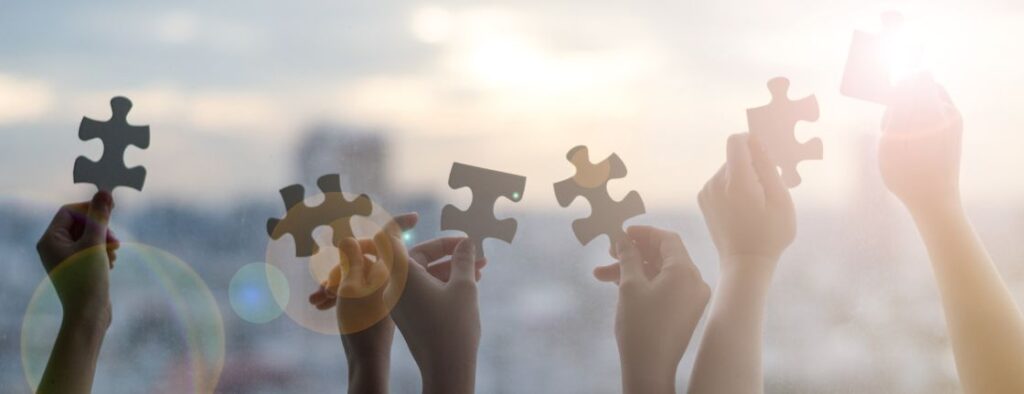 hands holding up pieces of puzzle